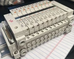 Smc Used Bank Of Solenoid Valves. (7) VQ1101-5 & (3) VQ1A01-5 With Exh, 26PIN. Fixed Price $266.00.